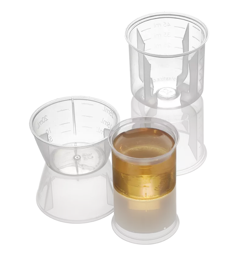 Three transparent beakers of different designs, one filled entirely with light brown liquid