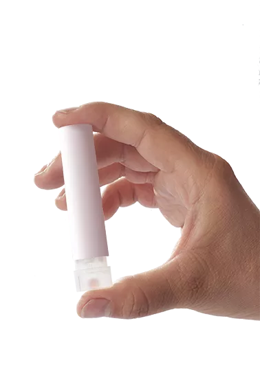 A hand holding the unmarked white Press and Take