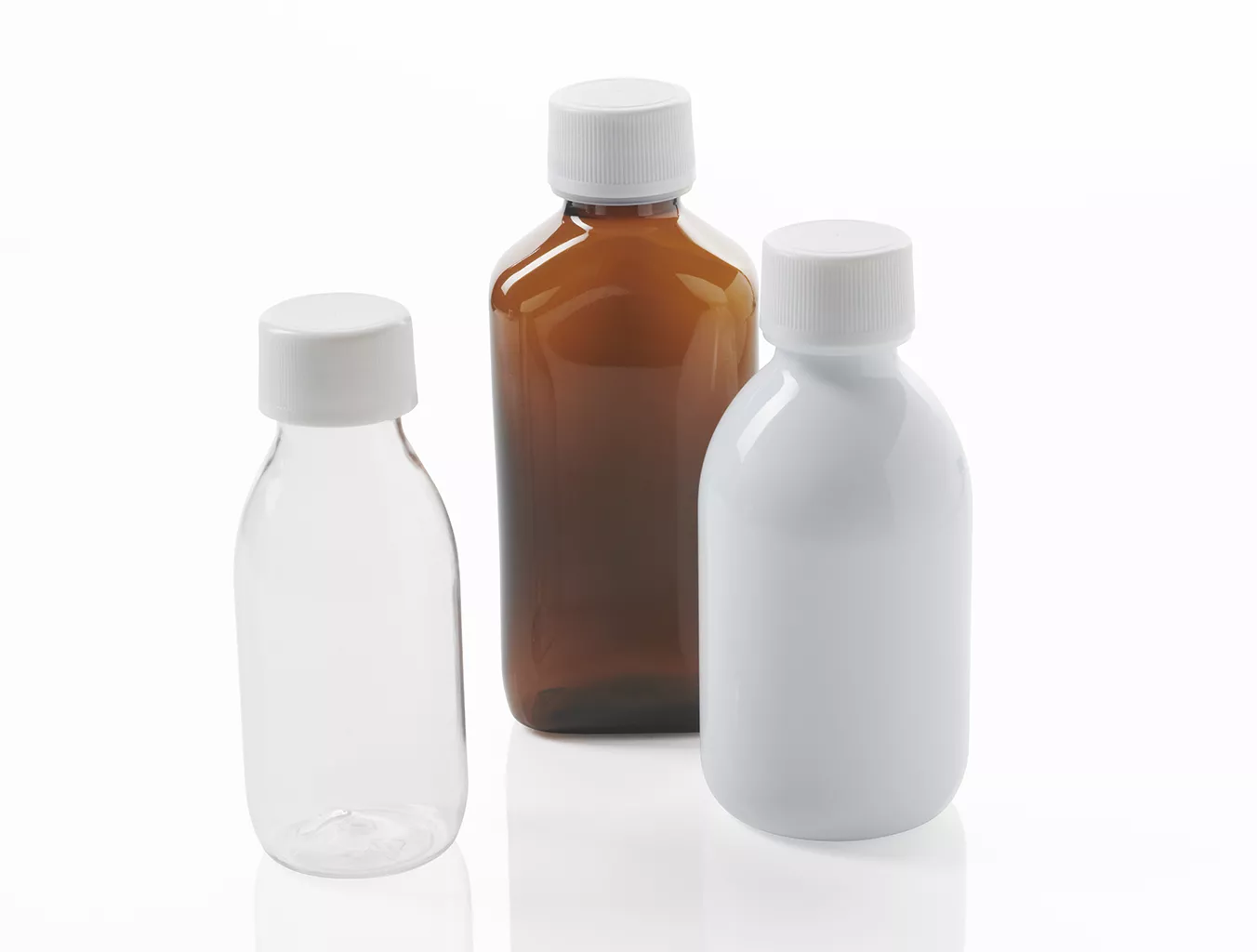 Three PET bottles in different shapes and colours: rectangular and round, amber, transparent and white.