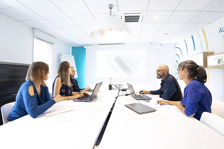 people sitting around a table and having a business conversation